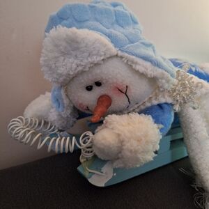 Blue and White Plush Toy on Wooden Sled